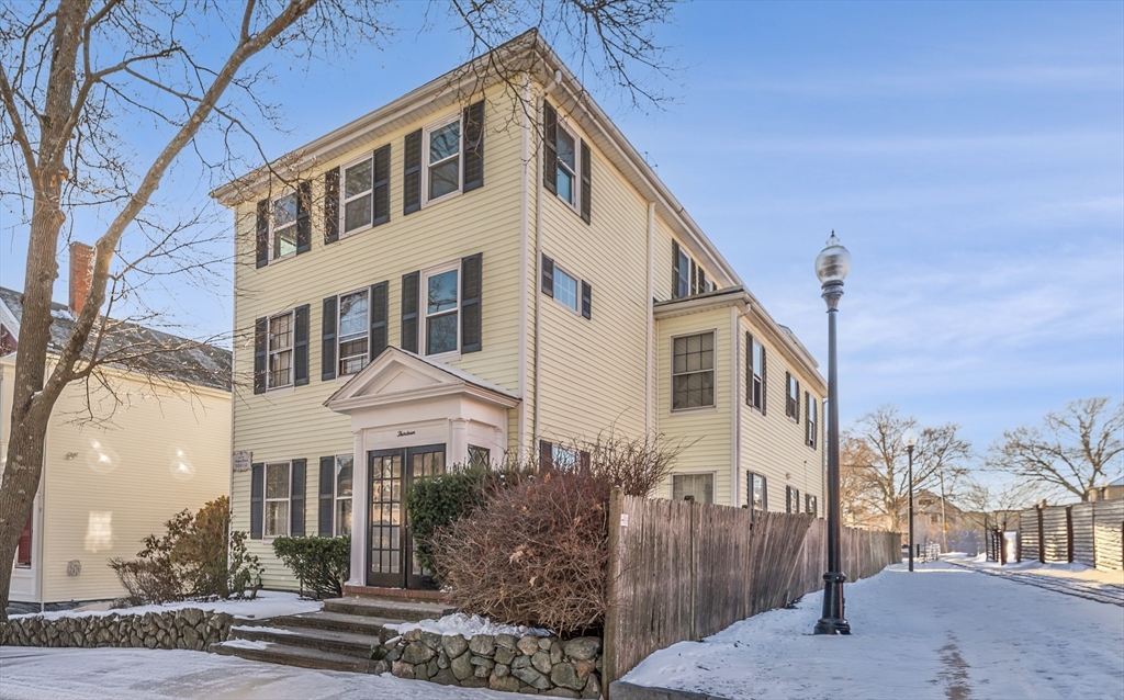 13 Washington Street, Unit 2 Beverly, MA 01915 - Photo 2 of 14 a front view of a house with a yard