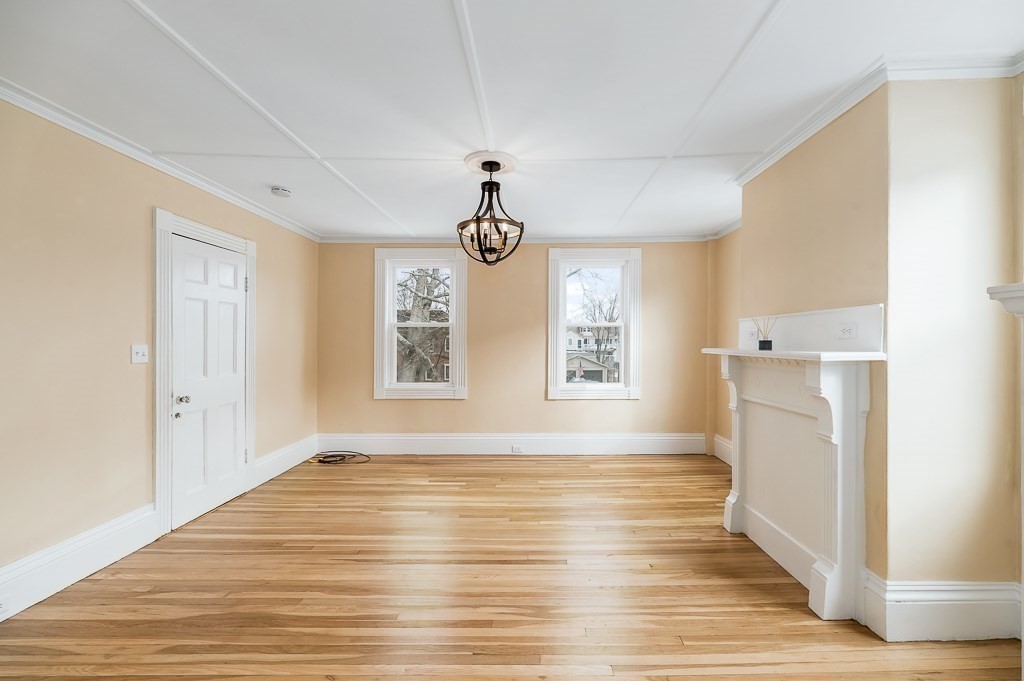 13 Washington Street, Unit 2 Beverly, MA 01915 - Photo 6 of 14 a view of empty room with wooden floor and fan