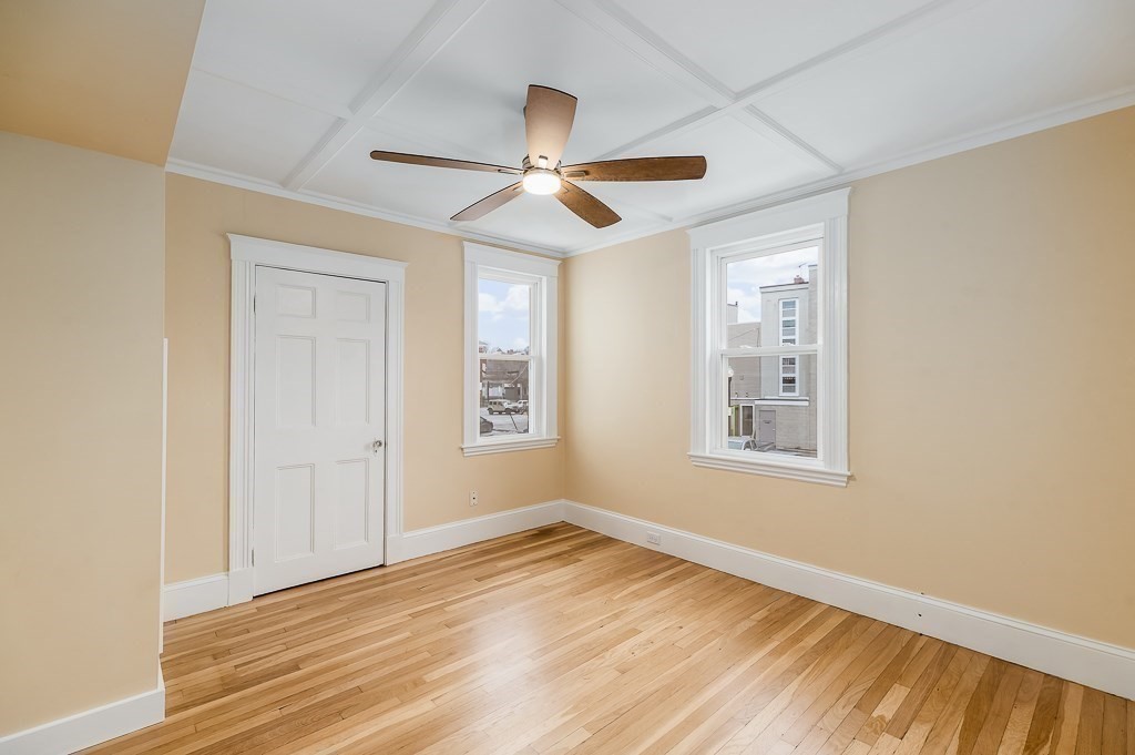 13 Washington Street, Unit 2 Beverly, MA 01915 - Photo 10 of 14 a view of empty room with wooden floor and fan