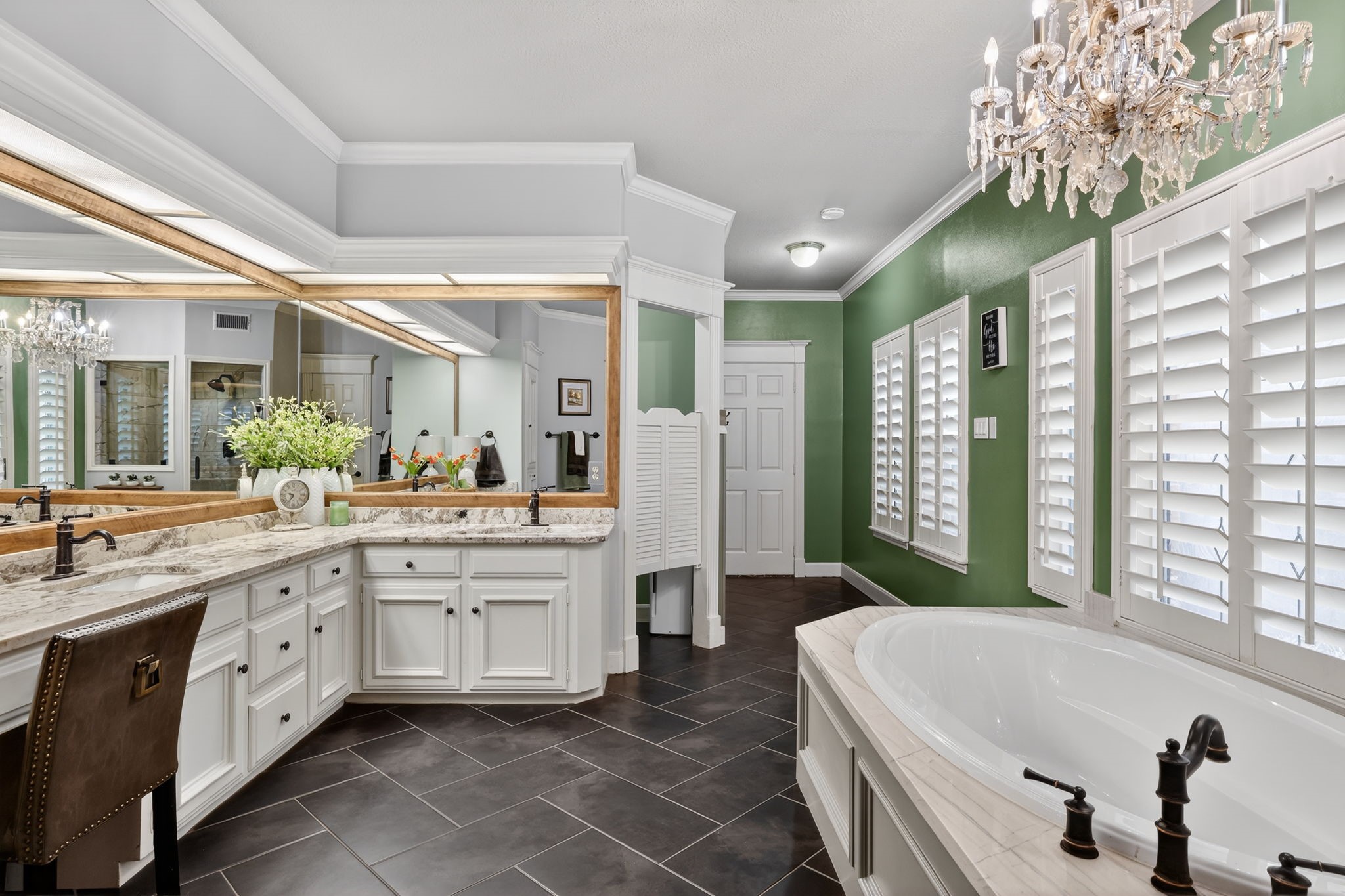 8711 Kennet Valley Road Spring, TX 77379 - Photo 17 of 37 a spacious bathroom with a double vanity sink a large mirror a bathtub and next to a window