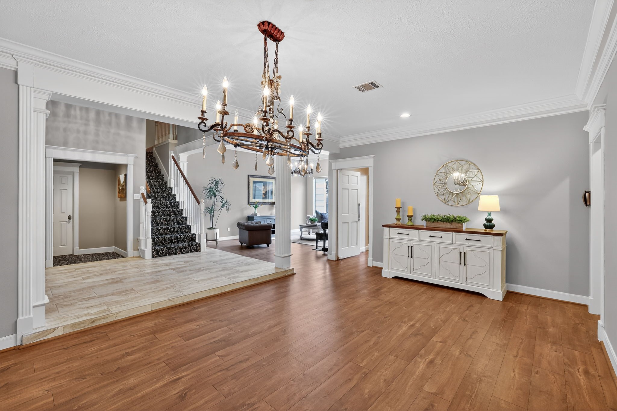 8711 Kennet Valley Road Spring, TX 77379 - Photo 4 of 37 a view of a living room and kitchen with furniture wooden floor and chandelier