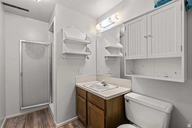 320 North 150 West Logan, UT 84321 - Photo 14 of 22 Bathroom with a stall shower, vanity, and dark wood-style floors