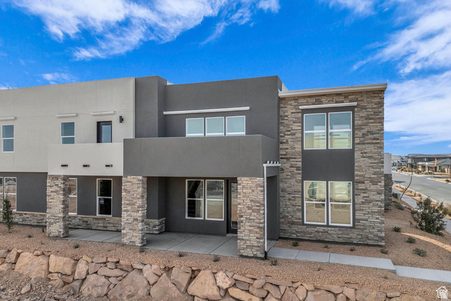560 Aqua Cove St. George, UT 84790 - Photo 1 of 27 Modern home with stucco siding, a patio area, and stone siding