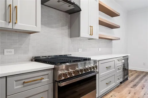 a stove top oven sitting inside of a kitchen