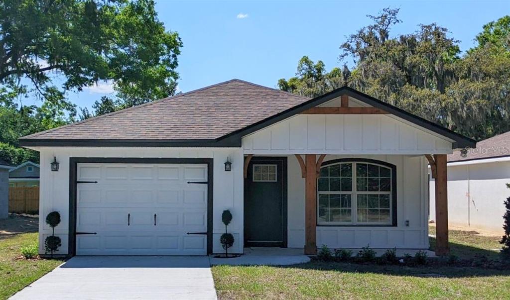 5717 Loop Road Lakeland, FL 33811 - Photo 1 of 1 a front view of a house with a garden