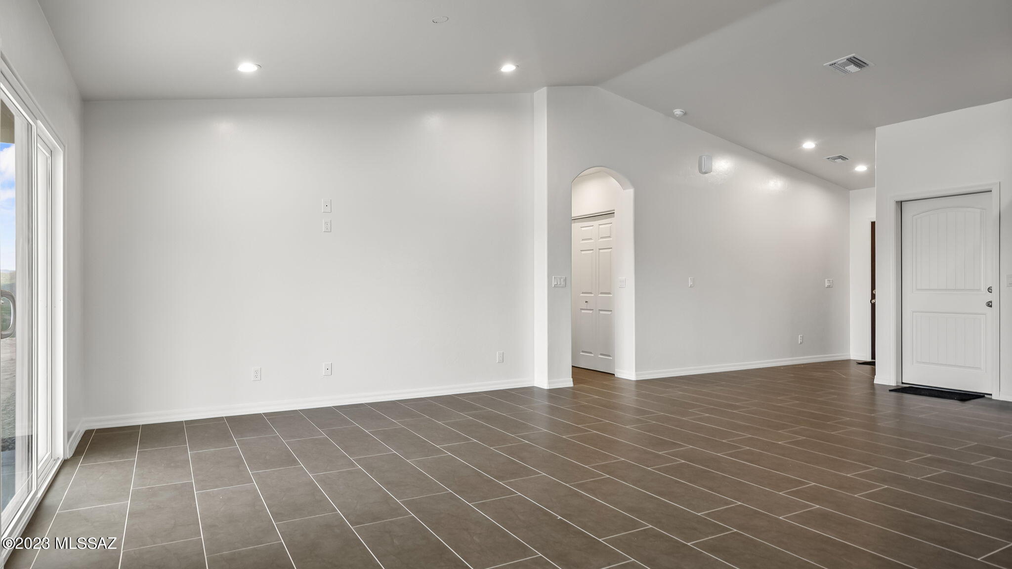 1019 Paseo Guebabi Rio Rico, AZ 85648 - Photo 12 of 25 an empty room with wooden floor and windows