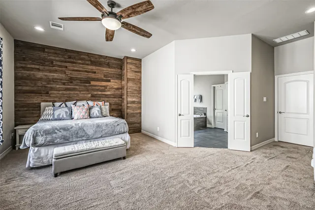 a bedroom with a bed and ceiling fan