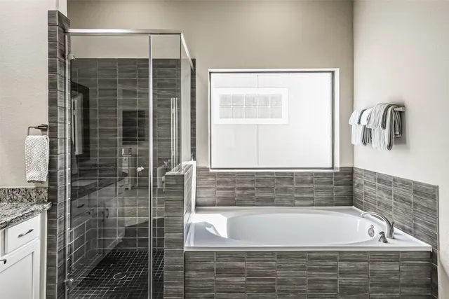 a bathroom with a bathtub and shower