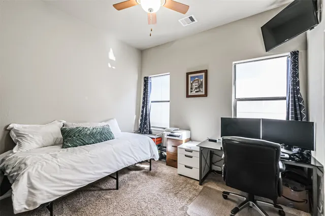 a bedroom with a bed and a window