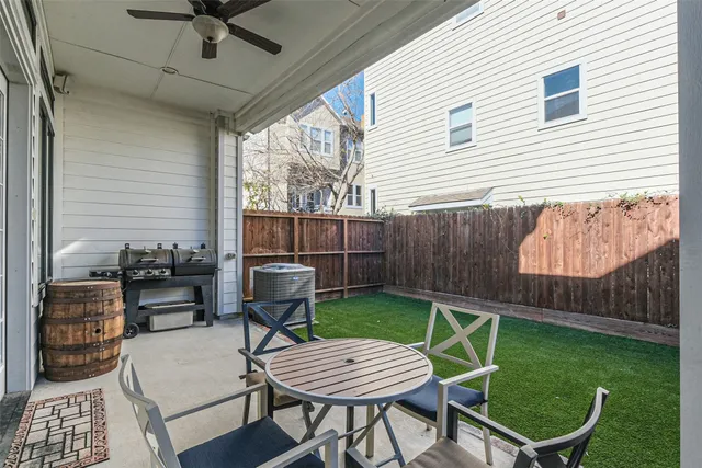 a view of a backyard with furniture and a garden