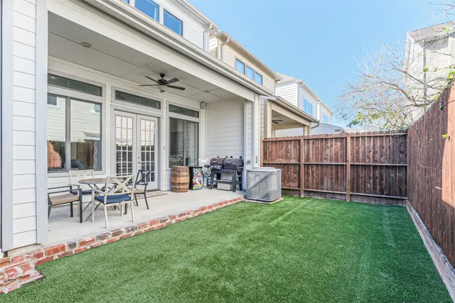 a view of a chair and table in backyard of the house