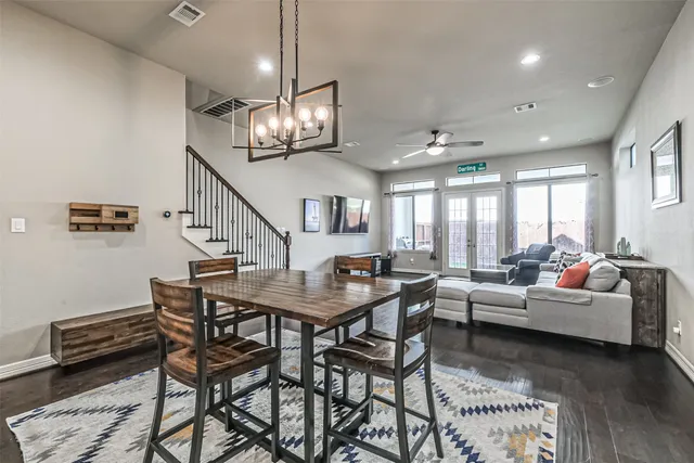 a living room with lots of furniture and a chandelier