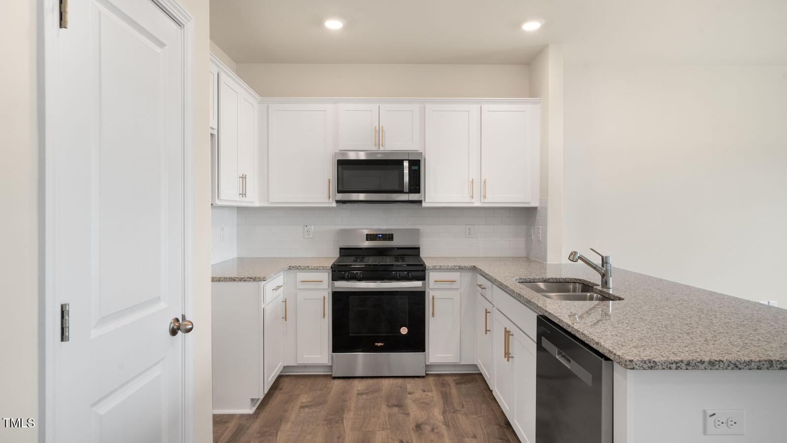 300 Perseus Street Angier, NC 27501 - Photo 5 of 26 a kitchen with stainless steel appliances granite countertop a stove and a sink