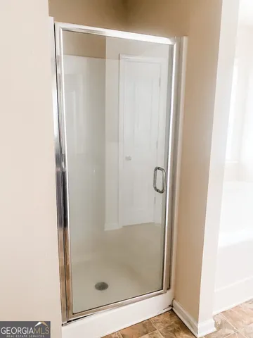 a bathroom with a glass shower door