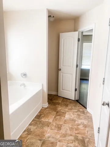a bathroom with a tub and a shower