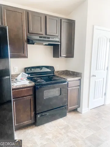 a kitchen with stainless steel appliances granite countertop a stove a microwave and a sink