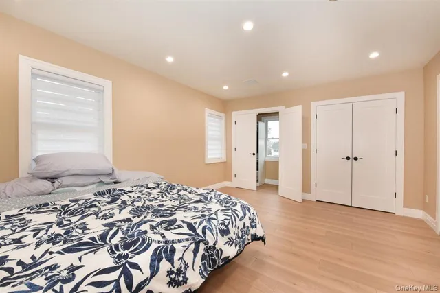 a spacious bedroom with a large bed and painting on the wall