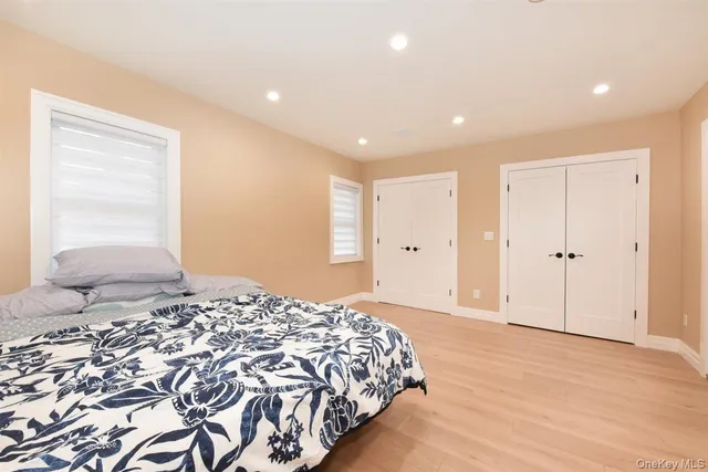 a bedroom with a large bed and painting on the wall