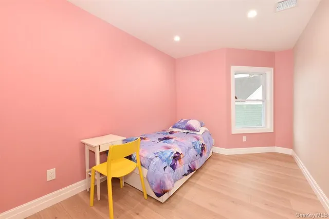 a bedroom with a bed a table and chair