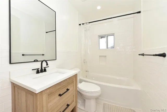 a bathroom with a sink toilet a mirror and shower