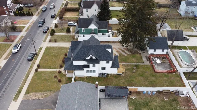 an aerial view of residential houses with outdoor space and parking