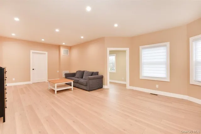 a living room with furniture window and wooden floor
