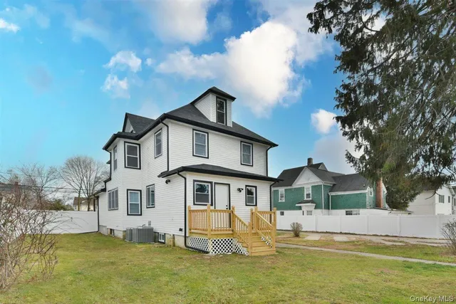 a front view of a house with a yard table and chairs