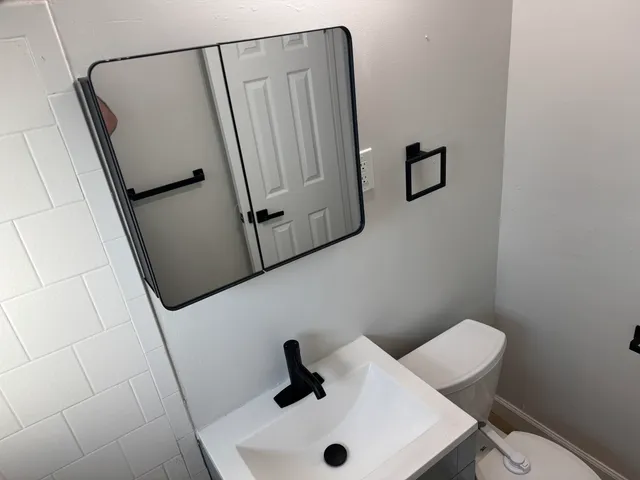 an empty room with wooden floor and entrance