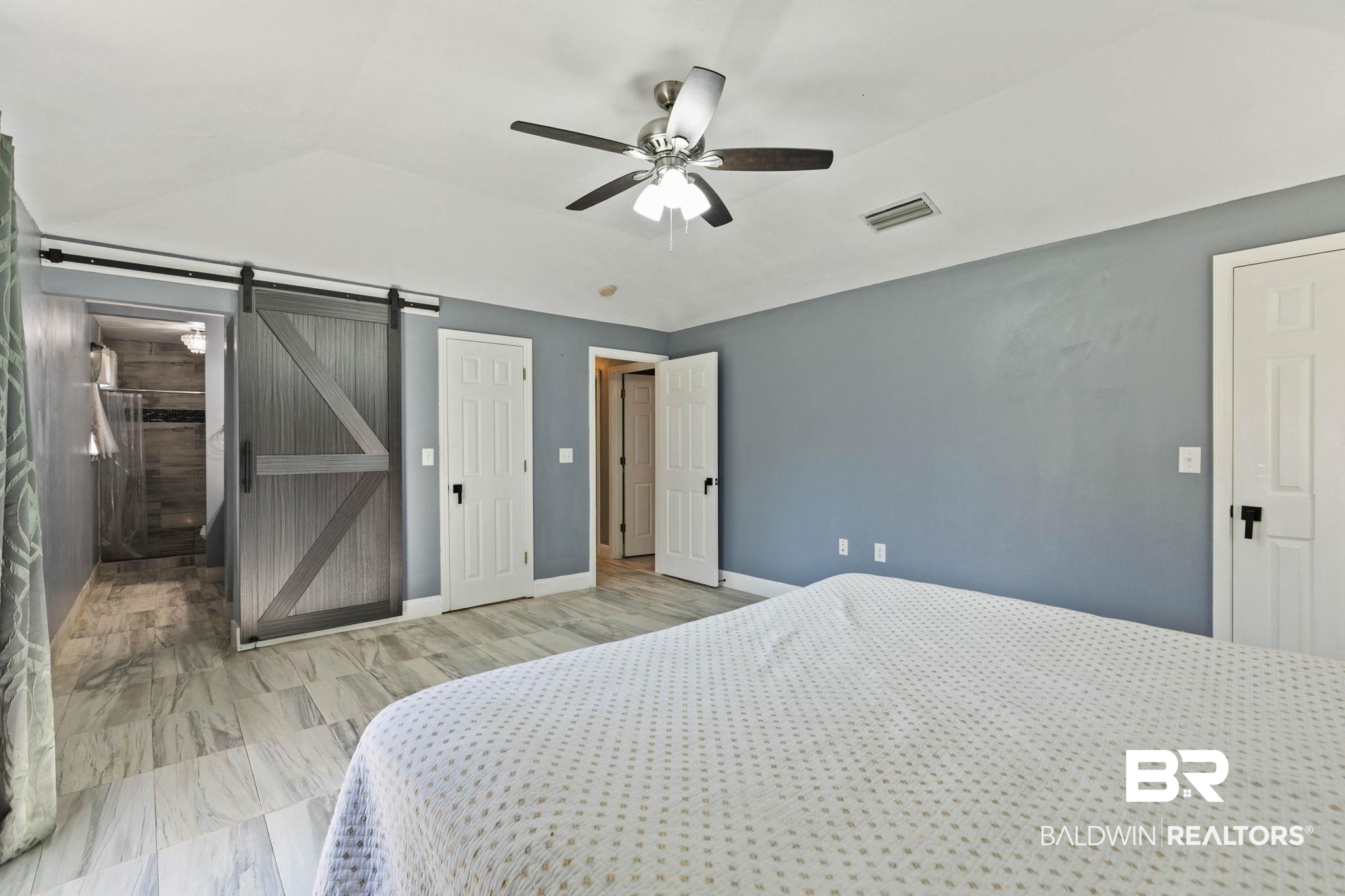 17366 Old Brady Road Bay Minette, AL 36507 - Photo 17 of 43 Bedroom featuring ceiling fan, vaulted ceiling, and a barn door