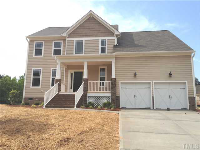 1100 Farmers Branch Road Willow Spring, NC 27592 - Photo 1 of 3 a front view of a house with a garage