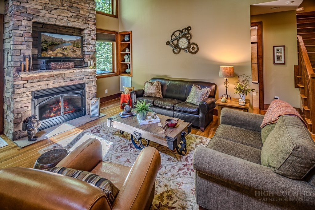 485 Woodlake Loop Road Elk Park, NC 28622 - Photo 6 of 44 a living room with furniture and a fireplace