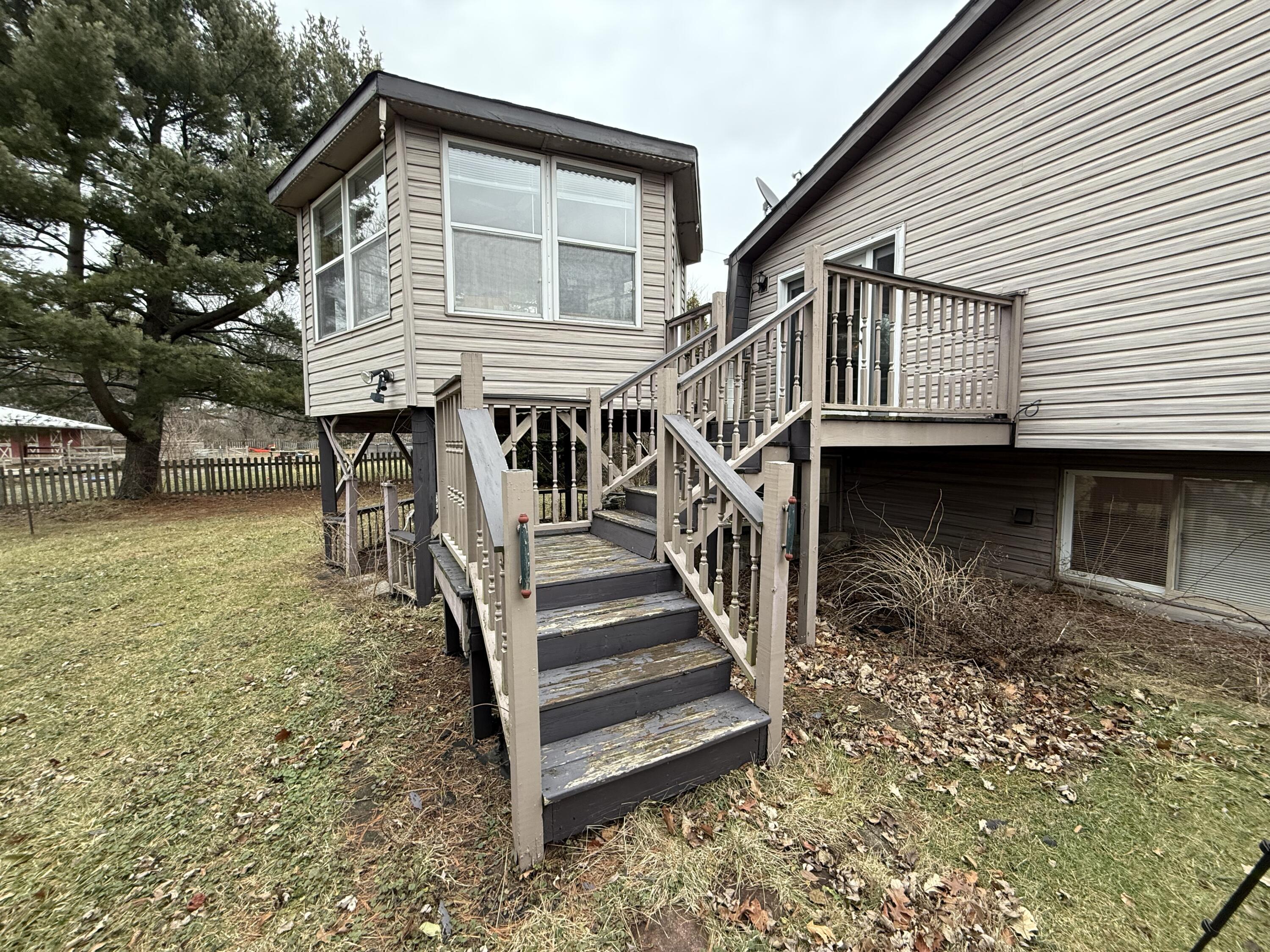 368 South 600th Street West Hebron, IN 46341 - Photo 78 of 87 a front view of a house with wooden stairs and a large tree