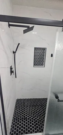 a bathroom with a shower and a toilet