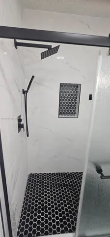 a bathroom with a shower and a toilet