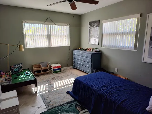 a bedroom with a bed and windows