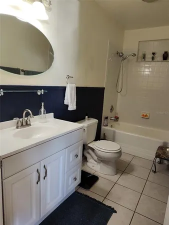 a bathroom with a sink mirror vanity and toilet