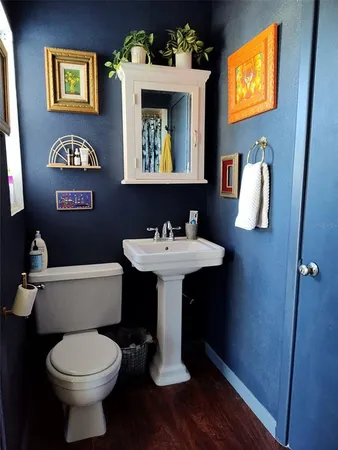 a bathroom with a toilet sink and mirror