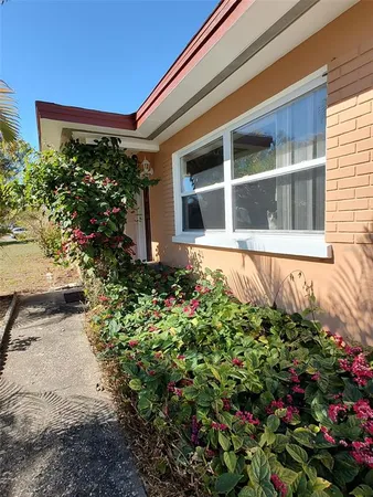 a view of a house with a flower garden