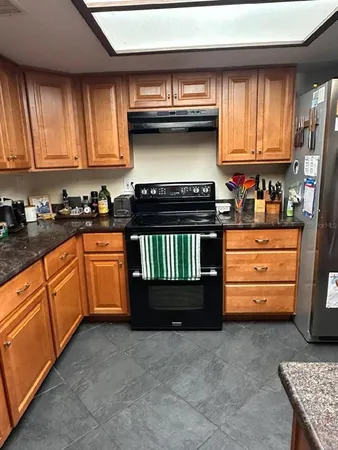 a kitchen with stainless steel appliances granite countertop a stove and a refrigerator