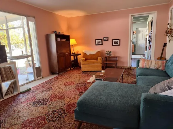 a living room with furniture window and a flat screen tv