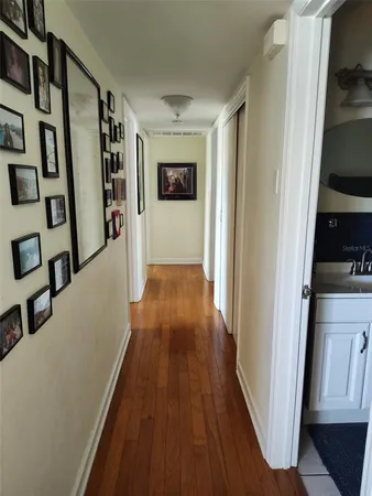 a view of a hallway with wooden floor and staircase
