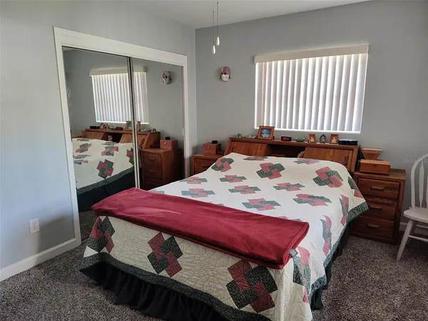 a bedroom with a bed and a table