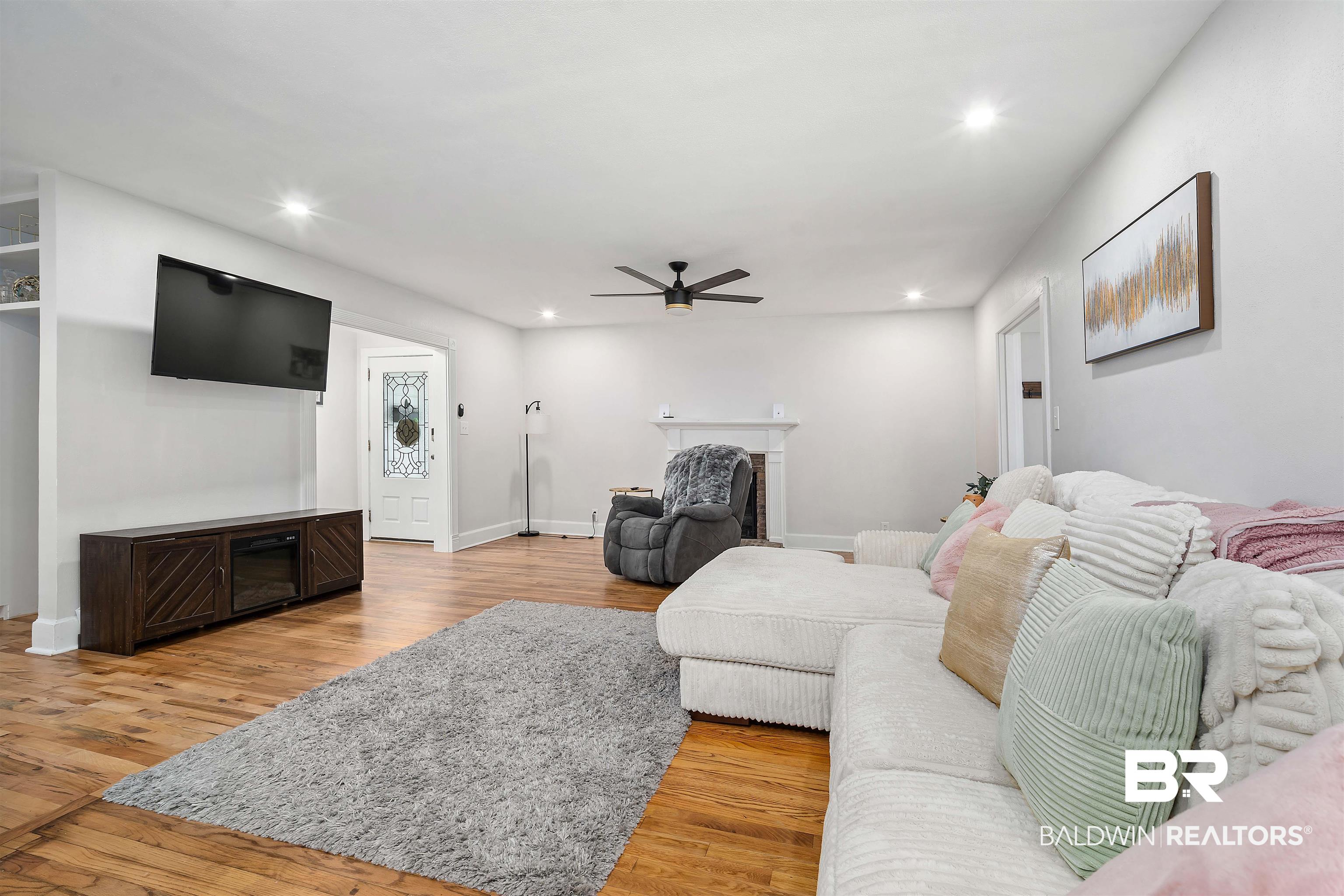 103 Emogene Place Mobile, AL 36606 - Photo 6 of 32 Living area with a fireplace, light wood-type flooring, a ceiling fan, and recessed lighting