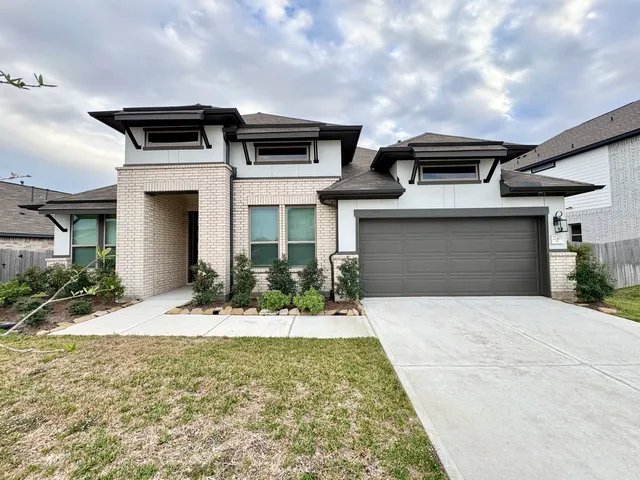 a front view of a house with yard
