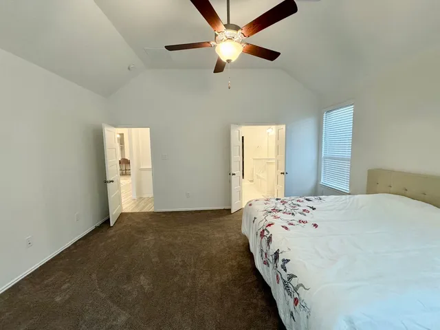 a bedroom with bed and window