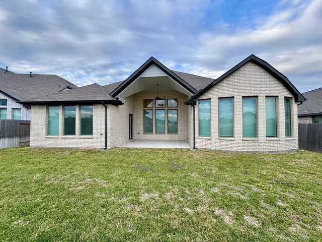 a view of house with yard and entertaining space