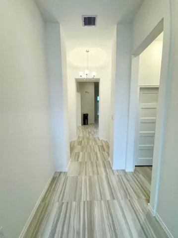 a view of a room with wooden floor staircase and a hallway