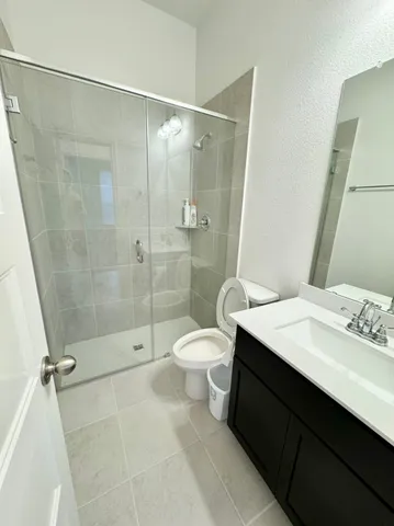 a bathroom with a double vanity sink toilet and shower