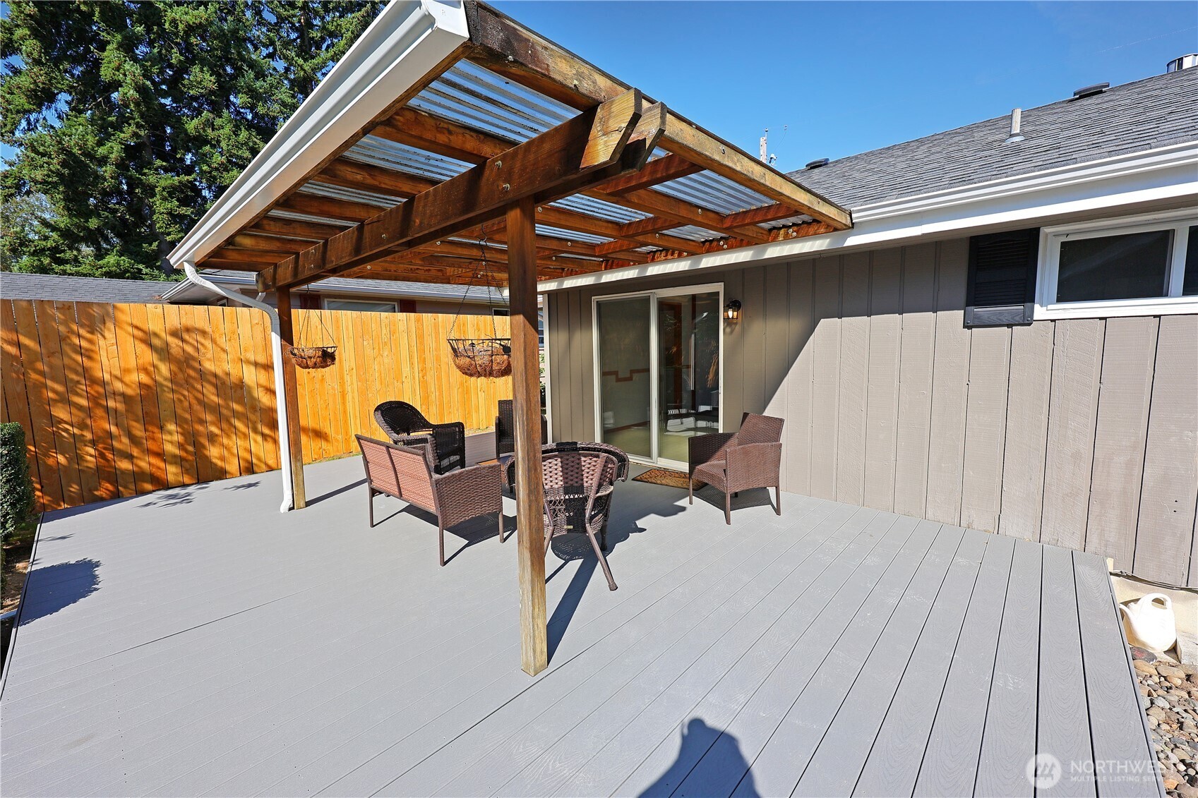908 Willow Street Sumner, WA 98390 - Photo 20 of 32 a roof deck with table and chairs and wooden floor