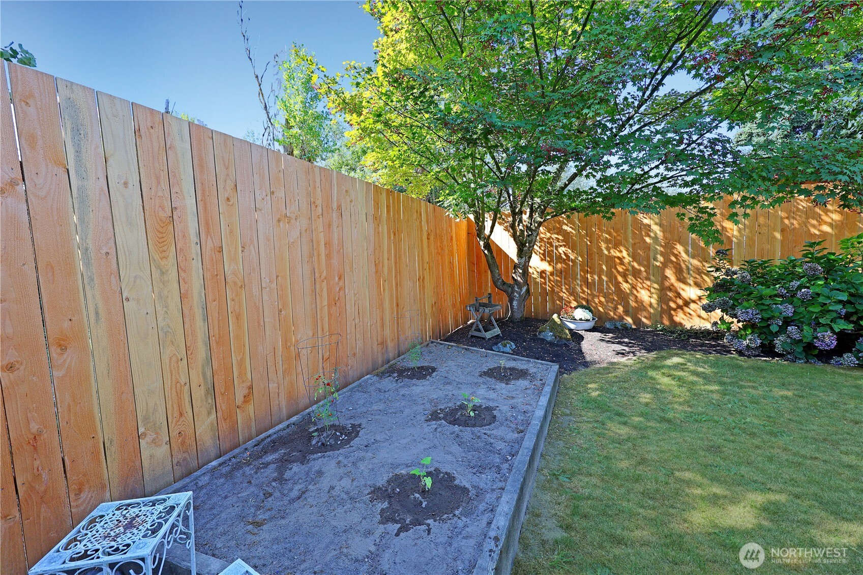 908 Willow Street Sumner, WA 98390 - Photo 24 of 32 a view of a backyard with wooden fence